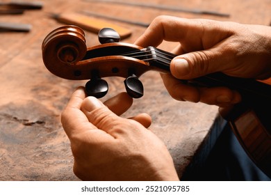 Luthier's hands tuning a violin - Powered by Shutterstock - Get 15% off with code: PIKWIZARD15