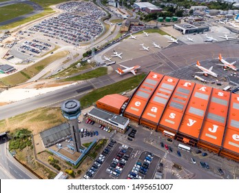 Luton, UK - June 05 2019: View From Above The Terminal At Luton Airport Showing The EasyJet Hanger And Control Tower With Planes On Taxiway - London Luton, UK On June 05, 2019