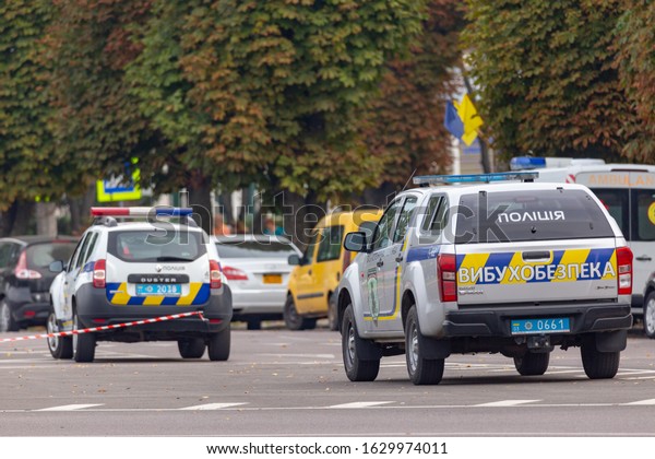 Lutsk, Ukraine - 09-08-2019: Police cars parked\
on the road with a do not cross and ambulance in the background.\
Road closed due to\
accident.