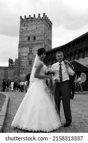 Lutsk, Ukraine - August 30 2009: Young Bride And Groom Posing In Old Castle