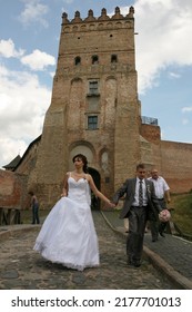 Lutsk, Ukraine - August 30 2009: Young Bride And Groom Posing In Old Castle