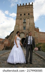 Lutsk, Ukraine - August 30 2009: Young Bride And Groom Posing In Old Castle