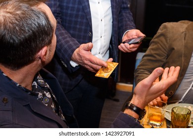 Lutsk, Volyn / Ukraine - November 17 2017: Caucasian Men With Credit Card And Mobile Phone In Restaurant. Shallow Depth Of Field.