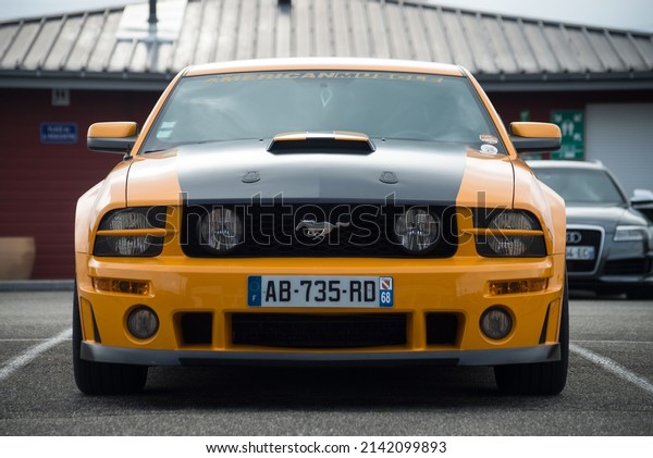 Lutterbach -\
France - 3 April 2022 - Front view of orange and black ford mustang\
500 GT cars parked in the street\
