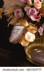 Lux Interior Bouquet With Pink Roses, Red Calla Lilies, Protea, White Hydrangea, And Golden Eucalyptus Branches In A Red Gold Metal Vase.