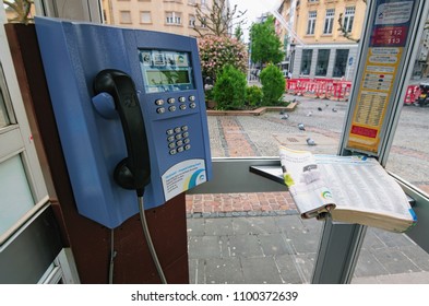 Luxembourg, Luxembourg–MAY 01, 2018: Close Up Detail Of Public Telephone Booth With Telephone And Open Phone Book Inside. 