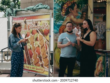 Luxembourg, Luxembourg -22 July 2021. Three People: One Guy And Two Girls Eating Ice Cream In The City Center, Close-up Side View.