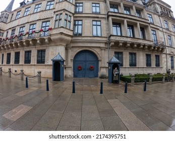 Luxembourg City, December 4, 2021: Luxembourg Army Soldiers performing ceremonial guard duties in front of Grand Ducal Palace. Guard stands near the sentry box.