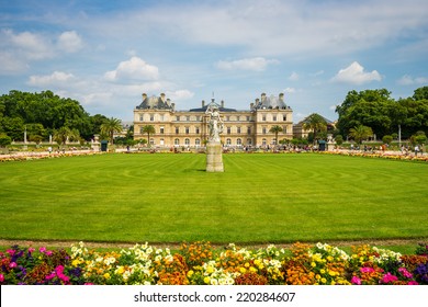 Luxembourg gardens and palace with puffy clouds in Paris, France