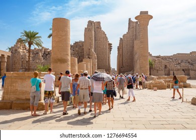 LUXOR, EGYPT - OСTOBER 18, 2012: Tourist group on a guided tour in the Temple of Karnak