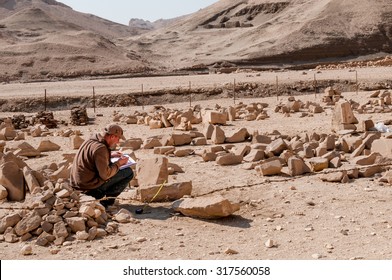 LUXOR, EGYPT - NOVEMBER 26, 2011: Archaeologists working near the Mortuary Temple of Queen Hatshepsut, located on the west bank of the Nile near the Valley of the Kings in Egypt.