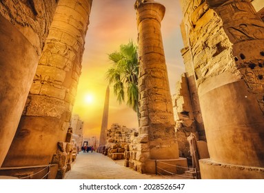 Luxor Karnak temple. The pylon with blue sky and pyramids - Shutterstock ID 2028526547
