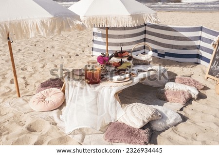 Luxuary setup picnic in Boho style on a beach, park. Bachelorette party, birthday celebration outdoors, wedding. 