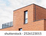 Luxurious apartments, fragment of the facade of a modern brick building, Corner of building, Fragment of a modern apartment building in front. Very modern apartment house







