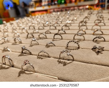 A luxurious array of sparkling rings showcased elegantly in a jewelry store display. Ideal for concepts of luxury, fashion, and engagement, capturing the essence of style and elegance.