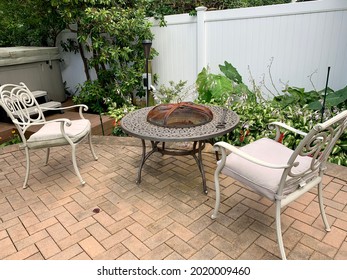 A Luxurious Backyard Set Up That Includes Brick Work, A Rod Iron Fire Place, Matching Outdoor Chairs, A Hot Tub, And A Tropical Garden. It's The Ultimate Entertainment Area Or Perfect For Stay-cations