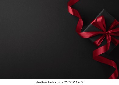 A luxurious black gift box wrapped with a vibrant red ribbon, ideal for Black Friday or festive occasions, symbolizing elegance and celebration - Powered by Shutterstock