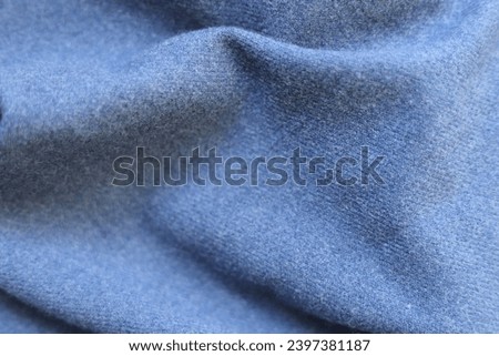 Luxurious blue cashmere scarf. Background, close up.
