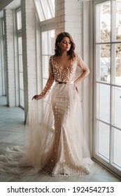 A luxurious bride in a wedding dress in the morning in her interior