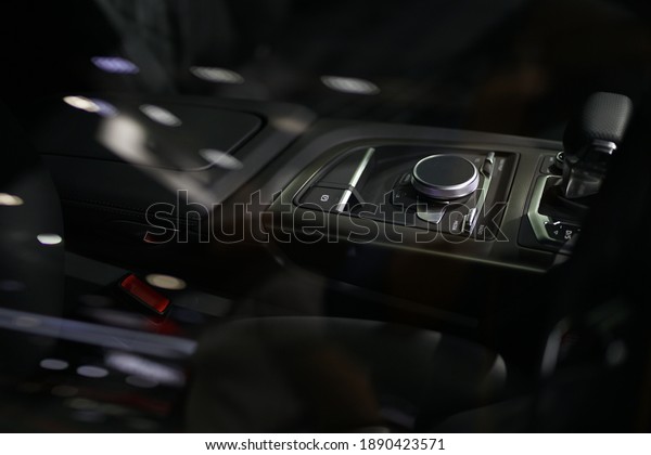 Luxurious car audio control buttons in the\
center of the luxury car\
console.
