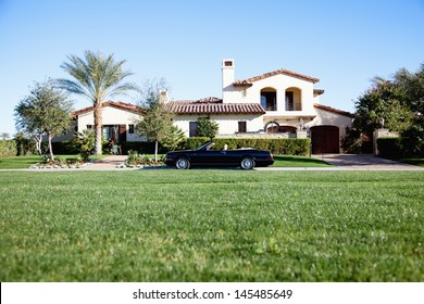 Luxurious car parked outside house in front yard