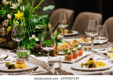 Luxurious dining table setup featuring gourmet appetizers, elegant glassware, floral centerpiece, and sophisticated decor, ideal for upscale events, weddings, banquets, and exclusive dinner parties.