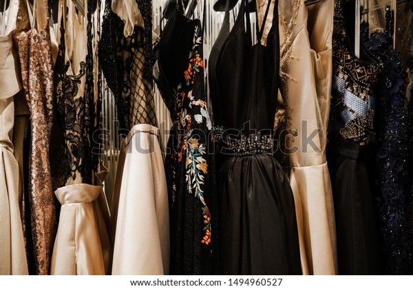 Luxurious\
evening night out sparkling dresses hanging on the rack. High\
fashion concept, haute couture, designer\
