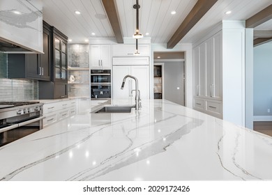 Luxurious high end kitchen with stainless appliances marble and glass tile