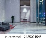 Luxurious hotel lobby with a sophisticated design. The lobby features a grand entrance with high ceilings and a polished marble floor that reflects the ambient lighting.