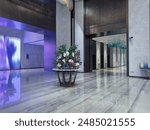 Luxurious hotel lobby with a sophisticated design. The lobby features a grand entrance with high ceilings and a polished marble floor that reflects the ambient lighting.