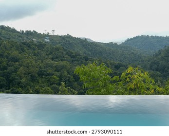  Luxurious infinity pool overlooking the dense tropical green mountains and valley of Vagamon hill station, Kerala, India.