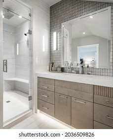 Luxurious Interior Bathroom With Barn Door White Tile Glass Shower And Makeup Counter