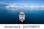 Luxurious large cruise ship sailing in calm blue waters and clear skies, Aerial view