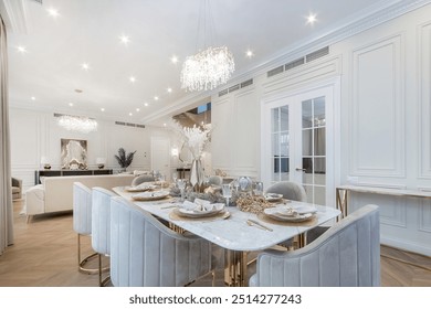 A luxurious living room in a neoclassical mansion. White room decor. A table with an 
elegant setting. - Powered by Shutterstock