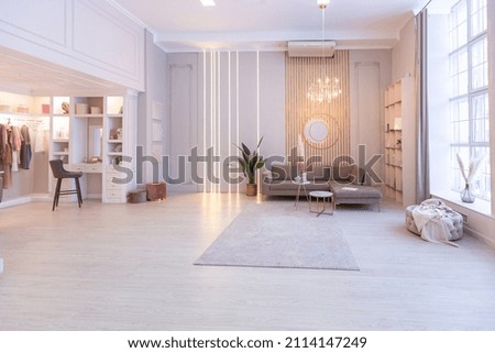luxurious modern interior of the living room of an expensive spacious bright apartment. upholstered furniture and decorative lighting, soft pastel colors and cozy atmosphere