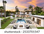 A luxurious modern mansion with a pool and landscaped garden at sunset. Southern California