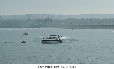 Luxurious modern private yacht and boat at the pier at night. Ship crossing skyline in the harbor in summer awesome nightly. Colorful lights of city glow shine reflected in water wave at nighttime. - Powered by Shutterstock