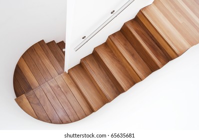 luxurious modern wooden staircase with curved landing wall