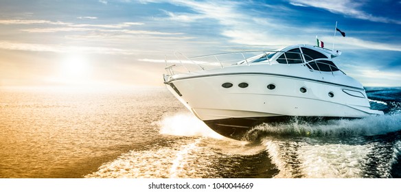Luxurious motor boat sailing the sea at dawn