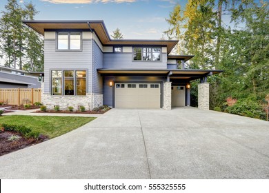 Luxurious New Construction Home In Bellevue, WA. Modern Style Home Boasts Two Car Garage Framed By Blue Siding And Natural Stone Wall Trim. Northwest, USA