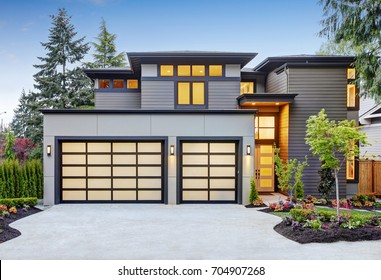 Luxurious New Construction Home In Bellevue, WA. Modern Style Home Boasts Two Car Garage Spaces With Glass Folding Doors Illuminated By Scones. Northwest, USA