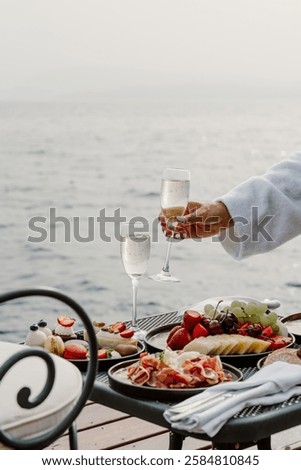 A luxurious oceanfront dining experience featuring a scenic view of the sea, elegant table setup, and gourmet cuisine. Perfect setting for a relaxing and sophisticated meal by the water in Greece