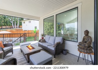 A Luxurious Spacious Deck With Stylish Patio Furniture With A Fire Pit Table Heater