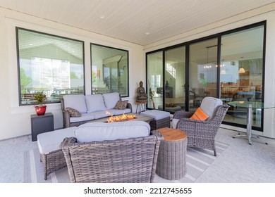 A Luxurious Spacious Deck With Stylish Patio Furniture With A Fire Pit Table Heater