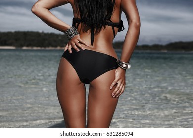 Luxurious tanned girl on the beach, Friends Summer Beach Party Festival Concept, relax on a tropical island, sexy bikini, fit butty, Sexy ass, Stylish silver accessories, low key photo, Radiant skin