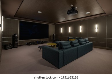 Luxurious theater room with large screen and lighting