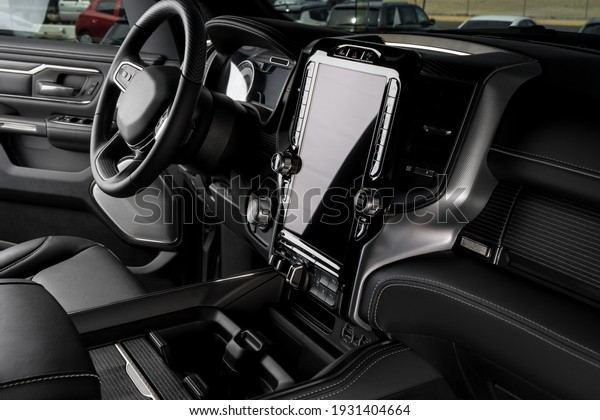 luxurious truck interior, steering wheel, leather\
seats and touchscreen\
display