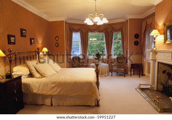 Luxurious Victorian Bedroom Big Brass Bed Stock Image