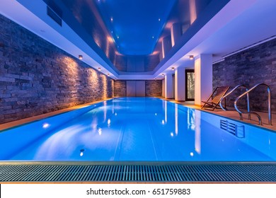 Luxurious villa swimming pool with brick walls, evening view
