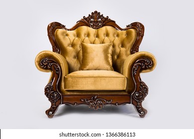 Luxurious vintage gold armchair on white background